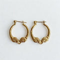 Pre-owned | Small 14k yellow gold ram head hoop earrings featuring a polished design and hinged posts.
