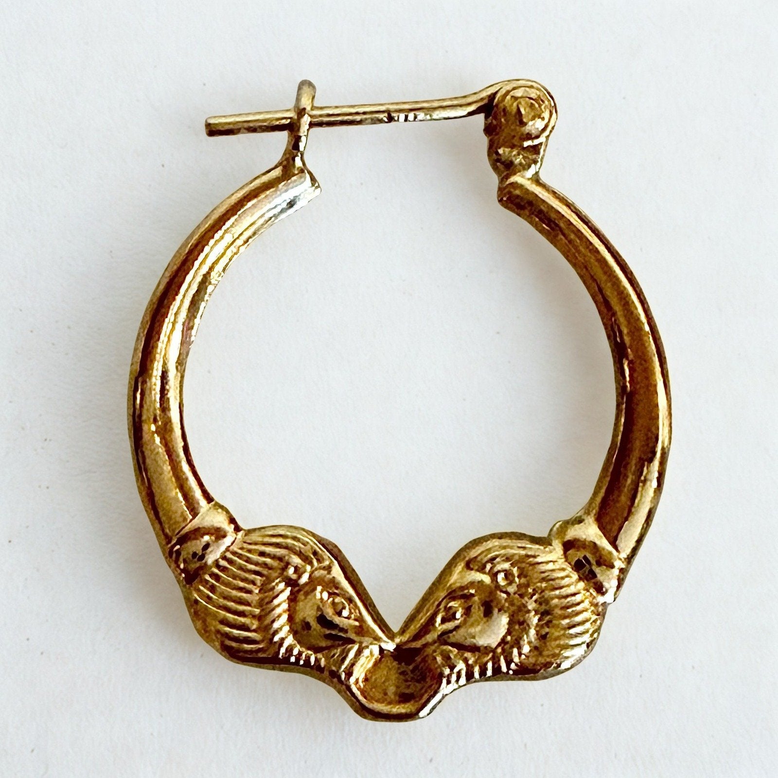 Pre-owned | Small 14k yellow gold ram head hoop earrings featuring a polished design and hinged posts.
